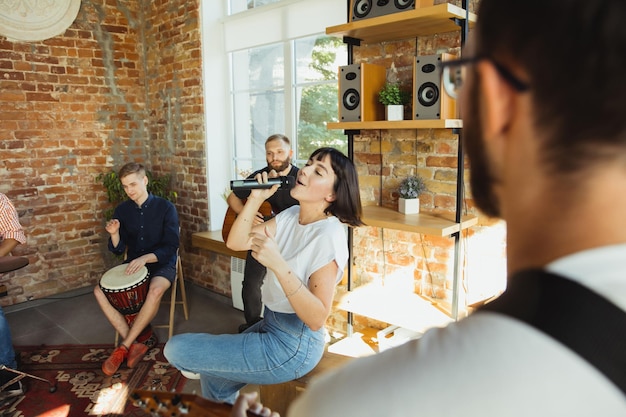 Group singing lesson with multiple participants learning vocal harmony techniques